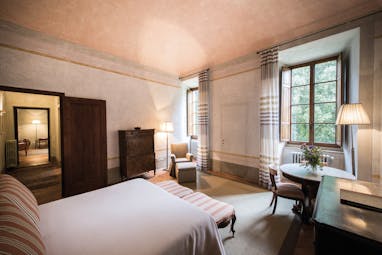 Borgo Pignano Tuscany suite bedroom doors leading to bathroom fresh décor