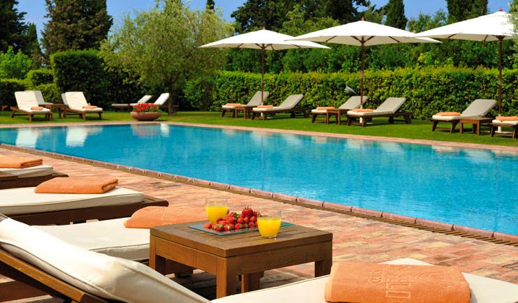 Hotel Borgo San Felice Tuscany pool sun loungers umbrellas