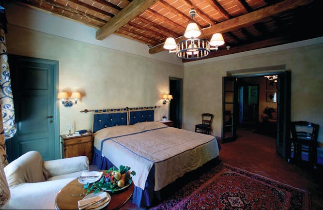 Hotel Borgo San Felice Tuscany suite bedroom armchair elegant décor