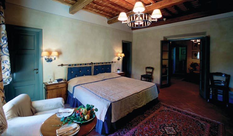 Hotel Borgo San Felice Tuscany suite bedroom armchair elegant décor