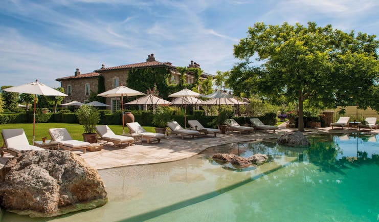 Borgo Santo Pietro Tuscany grounds pool and sunbathing in foreground