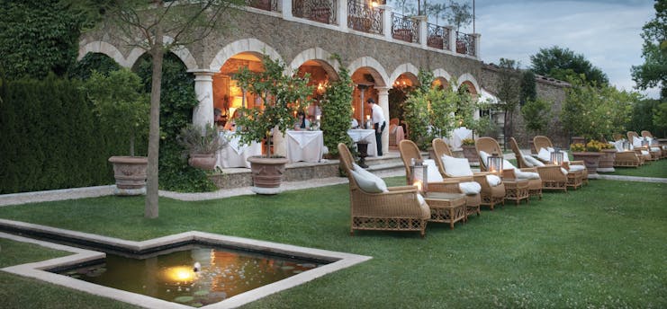 Borgo Santo Pietro Tuscany lawns outdoor seating area terrace restaurant