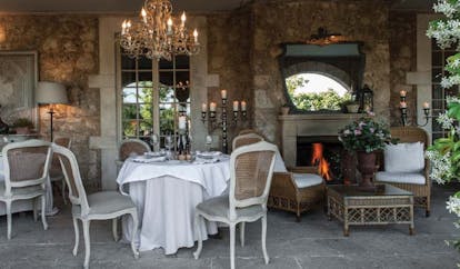 Borgo Santo Pietro Tuscany restaurant dining area fireplace 