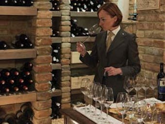 Borgo Santo Pietro Tuscany wine tasting wine cellar couple tasting wine waiter