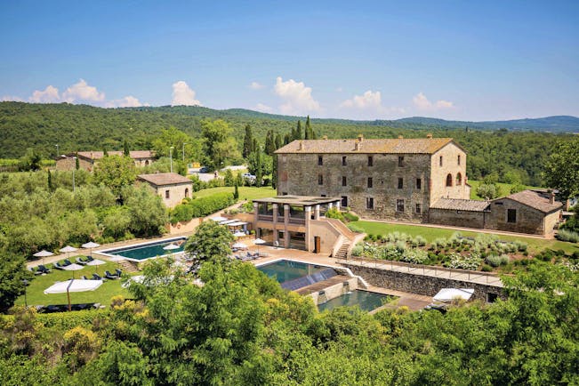 Castel Monastero Tuscany exterior shot pools hotel buildings surrounding countryside