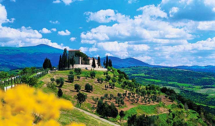 Castello di Velona Tuscany exterior shot of hotel on hillside overlooking Tuscan countryside