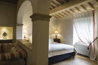 Castello di Velona Tuscany junior suite bed living area contemporary décor