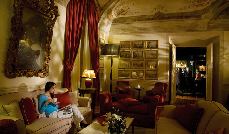 Grotta Giusti Tuscany giusti lounge indoor seating area woman on sofa ornate décor