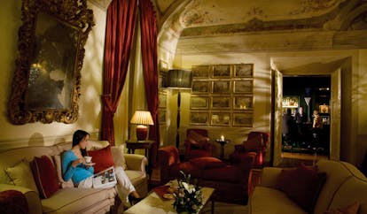 Grotta Giusti Tuscany giusti lounge indoor seating area woman on sofa ornate décor