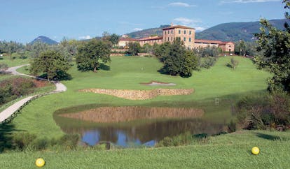 Grotta Giusti Tuscany golf course pond green hotel building in background
