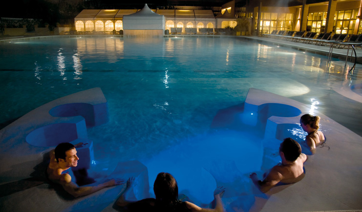 Grotta Giusti Tuscany pool at night people enjoying the jacuzzi