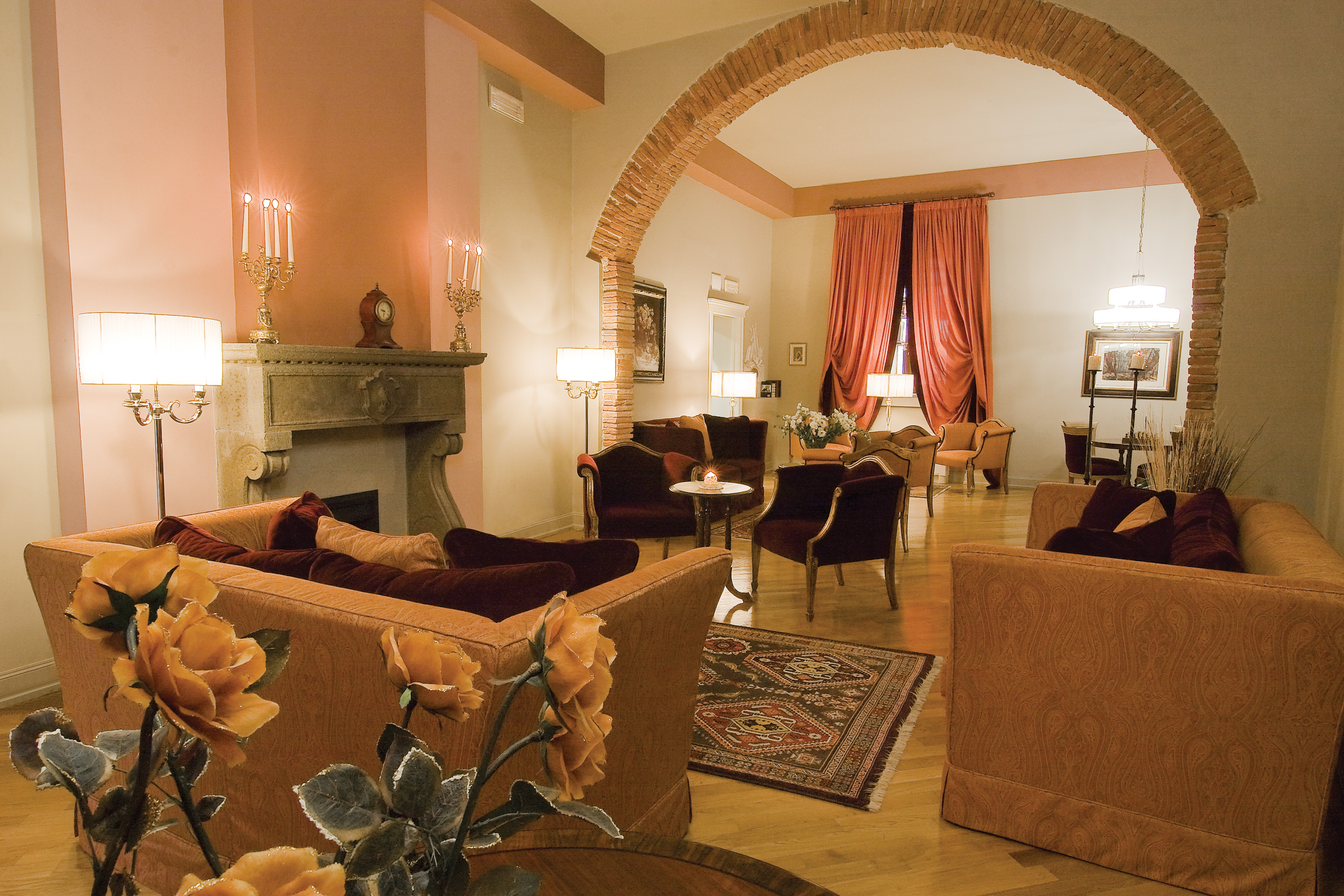 Lounge with sofas and arm chairs spread out for seating and flower arrangements 