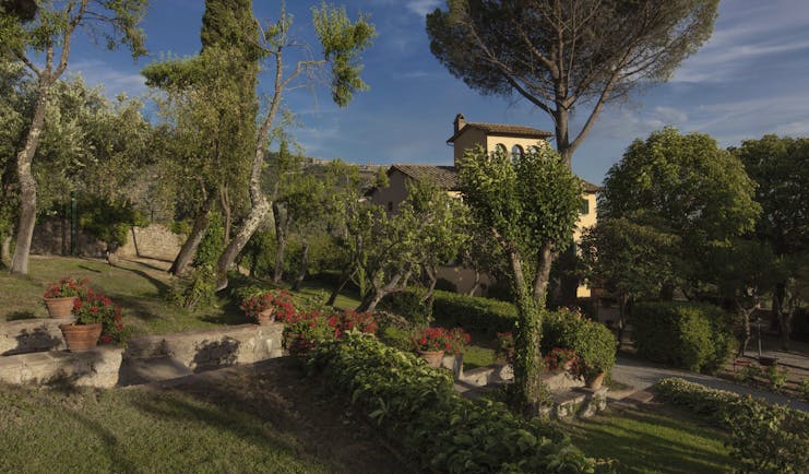 Il Faconiere Tuscany main hotel exterior gardens with trees and potted plants