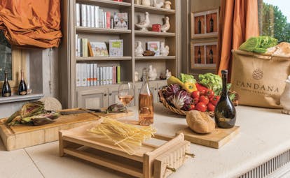 L Andana Tuscany cookery school pasta vegetables bread wine on table