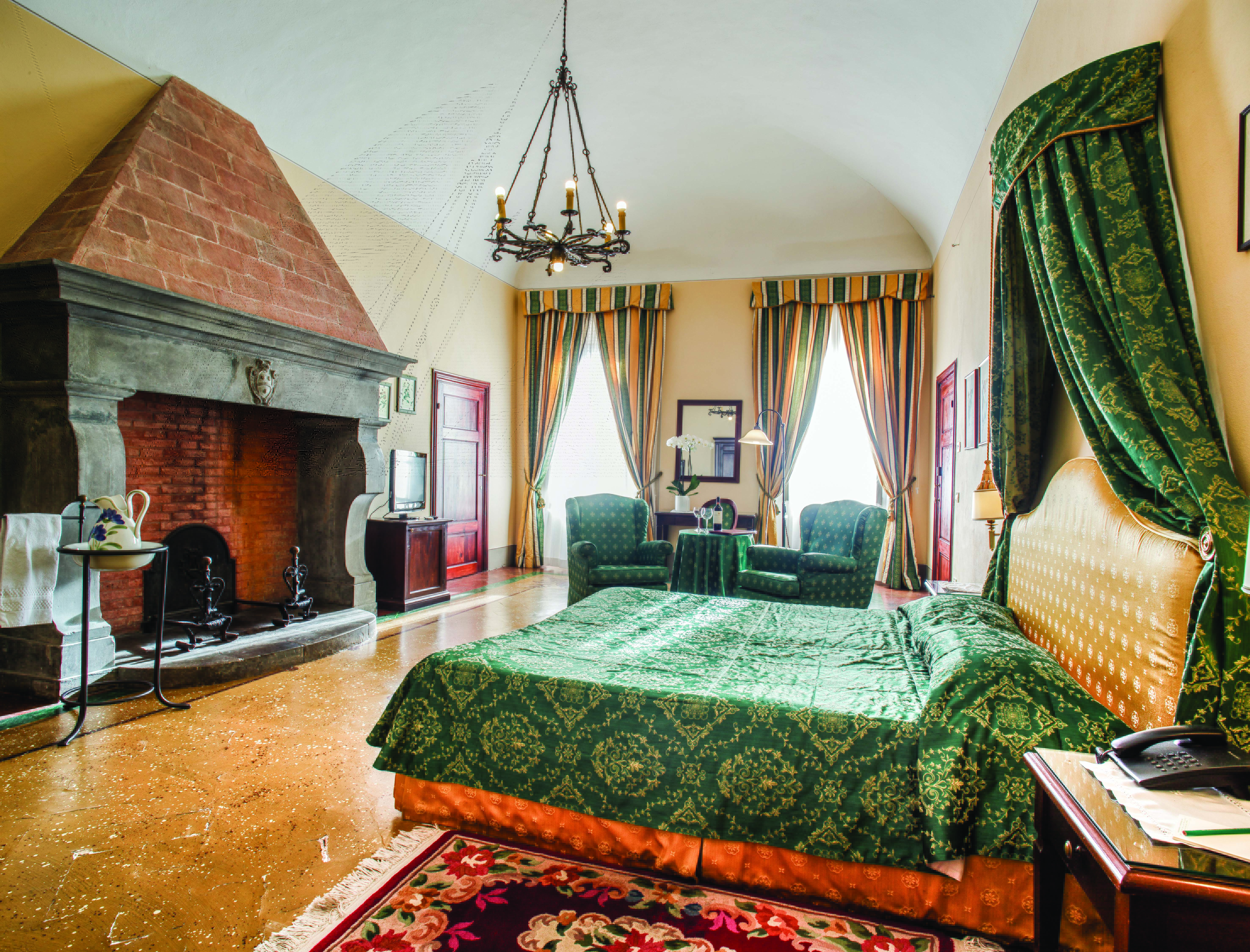Palazzo Leopoldo Tuscany junior suite traditional décor bed seating fireplace