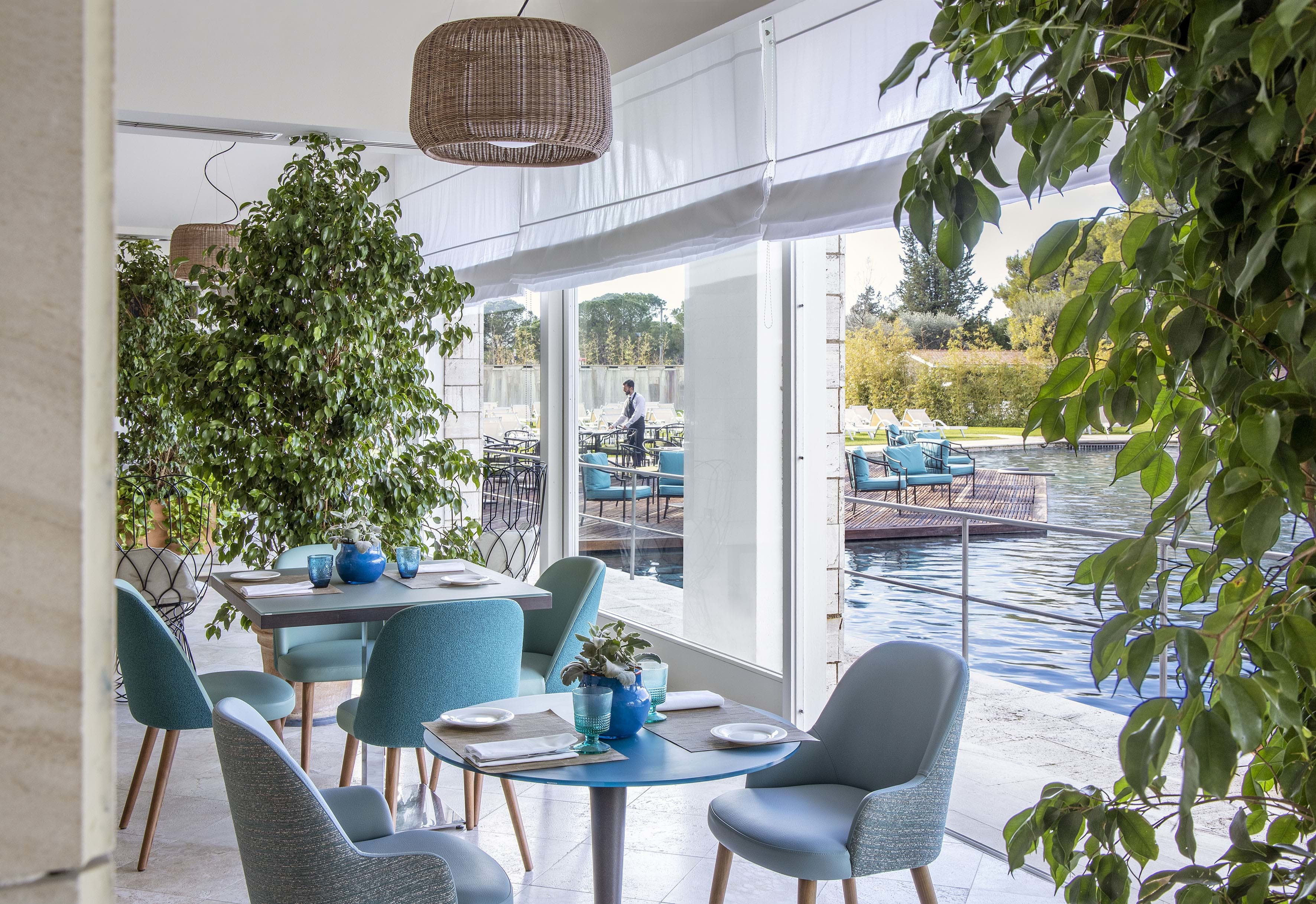 Turquoise seats in restaurant overlooking thermal pools