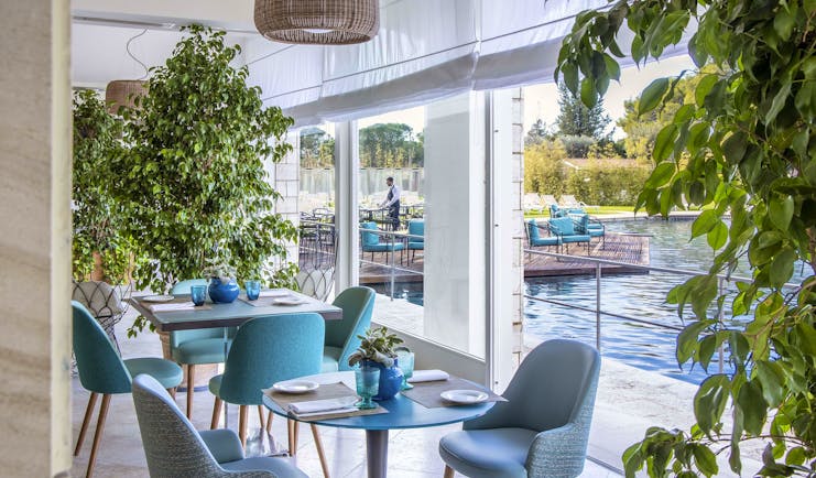 Turquoise seats in restaurant overlooking thermal pools
