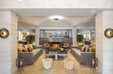Lobby area with grey sofas and white stone walls