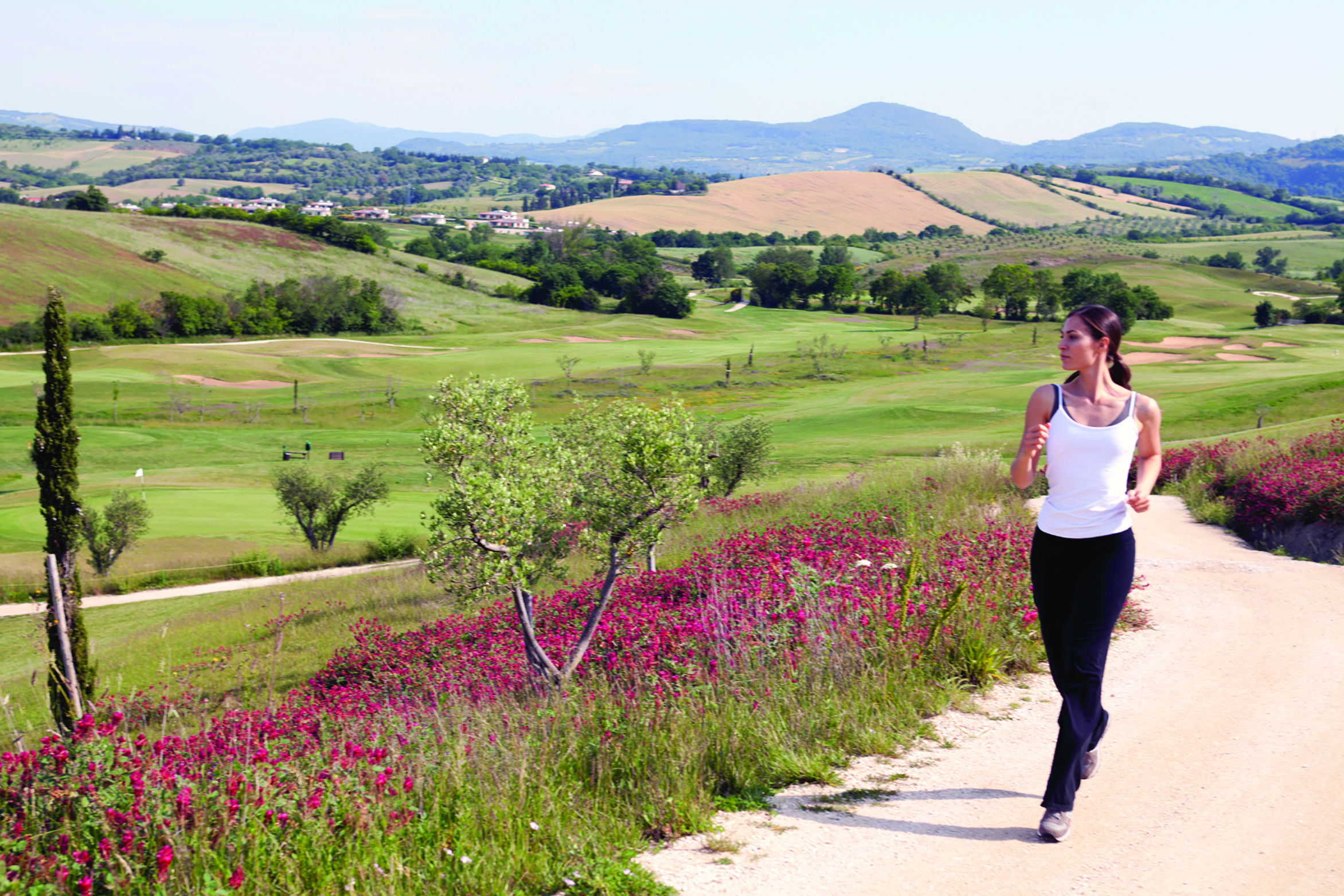 Terme di Saturnia Tuscany female jogging through the Tuscan countryside