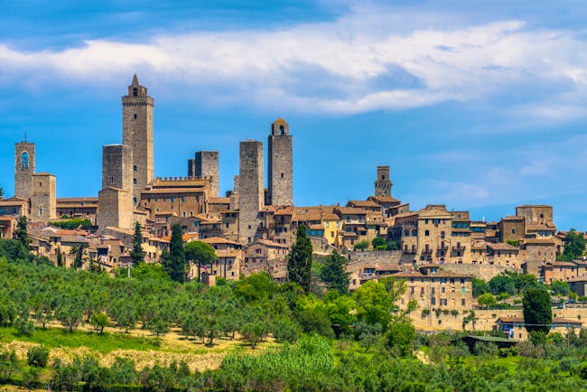 Outline against sky of the towers and houses of the Tuscan town of San Gimignano