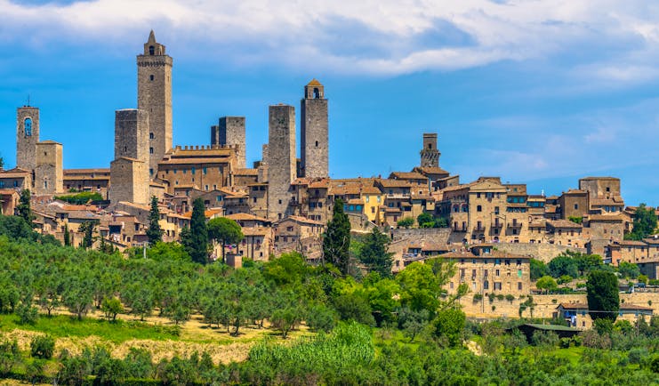 Outline against sky of the towers and houses of the Tuscan town of San Gimignano