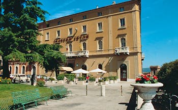 Hotel Brufani Palace Umbria exterior hotel building patio lawn tree