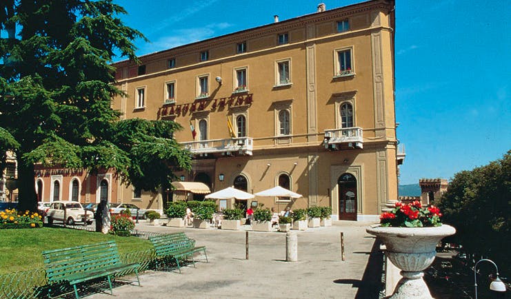 Hotel Brufani Palace Umbria exterior hotel building patio lawn tree