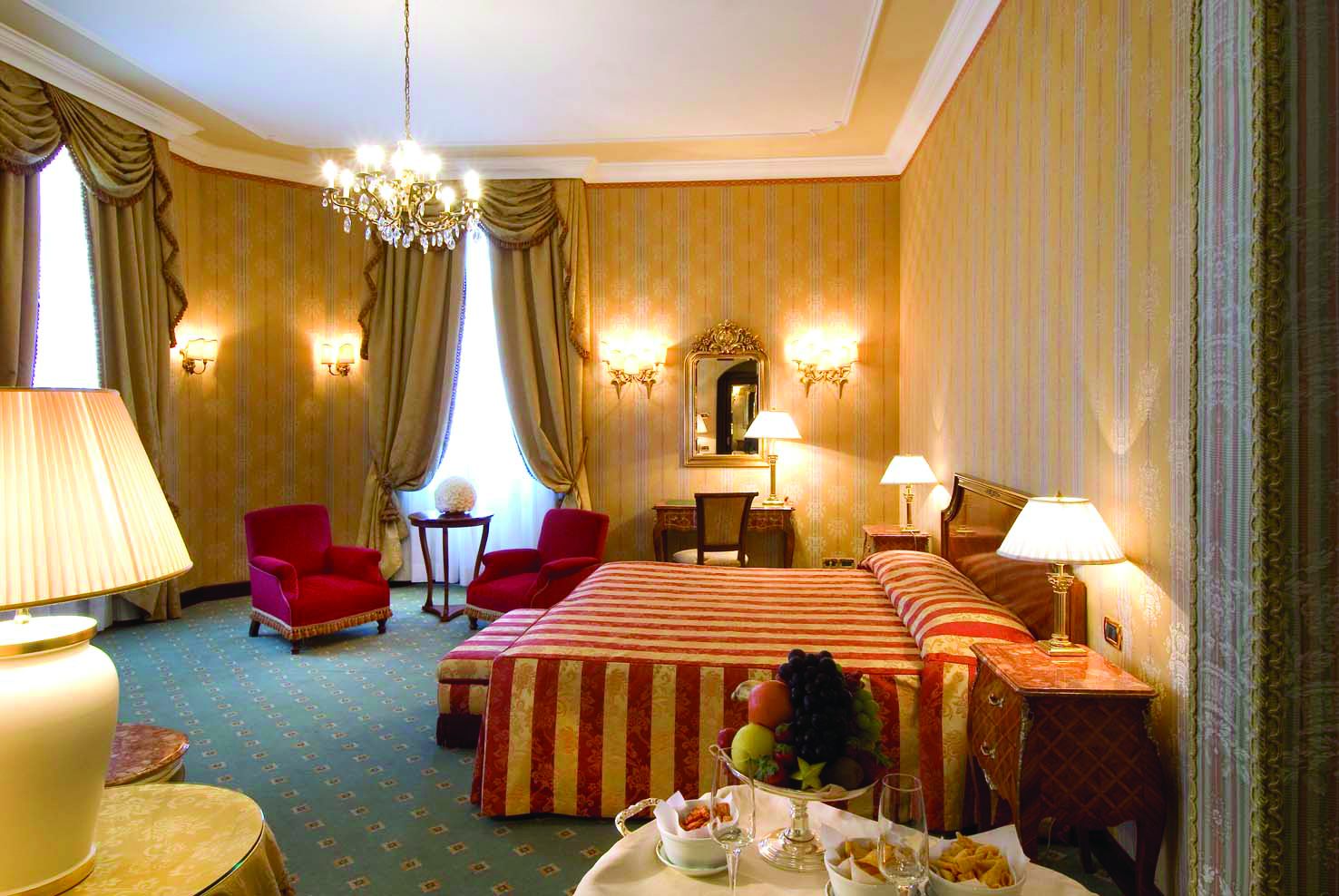 Hotel Brufani Palace Umbria suite bedroom bed armchairs ornate décor