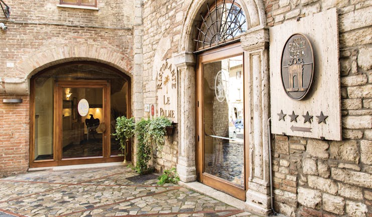 Hotel fonte cesia entrance with stone walls and big archway for door