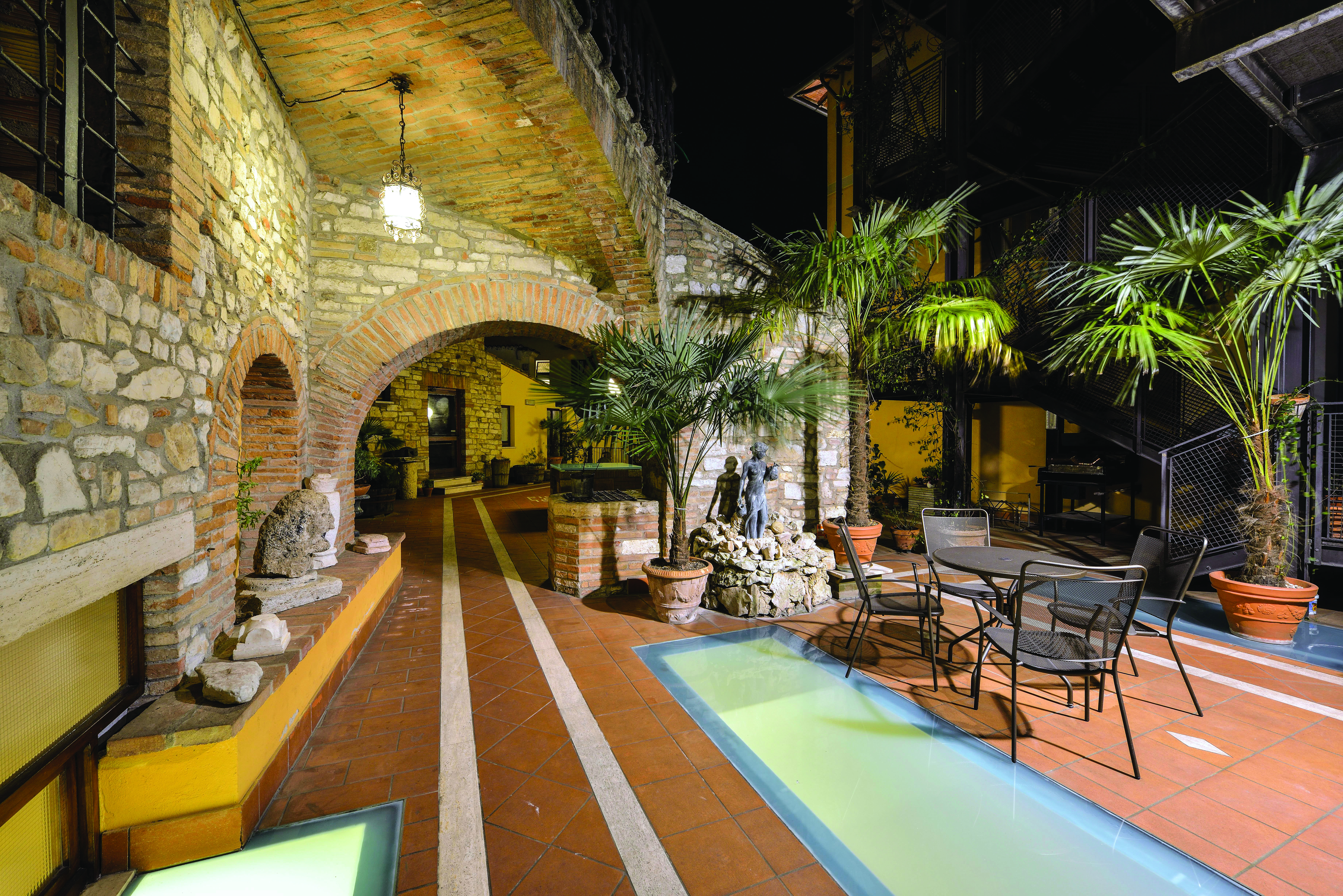 Outdoor terrace with palm trees and seating areas