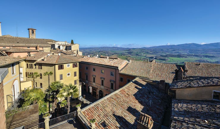 View looking out over the Hotel Fonte Cesia onto rooftops and green pastures