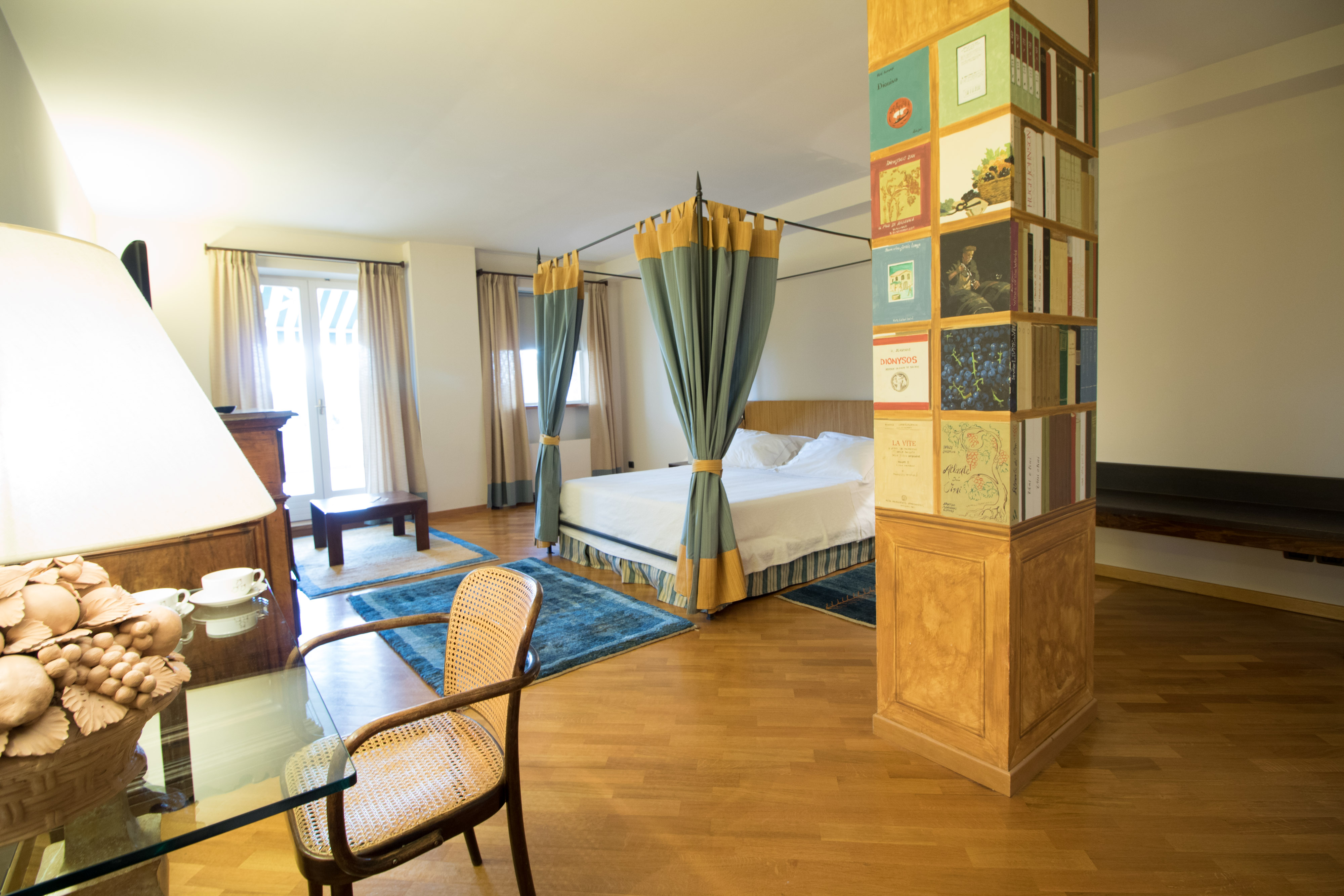 Yellow colours in large bedroom with pillar