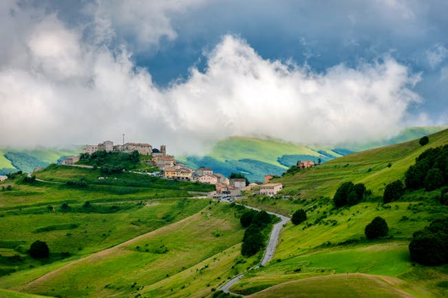 Green rolling hills of Umbria with hilltop village 