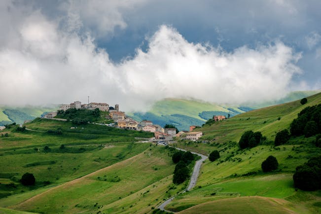 Green rolling hills of Umbria with hilltop village 