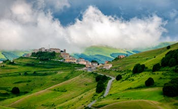 Green rolling hills of Umbria with hilltop village 