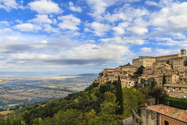 Perched town of Todi with fields in distance in Umbria