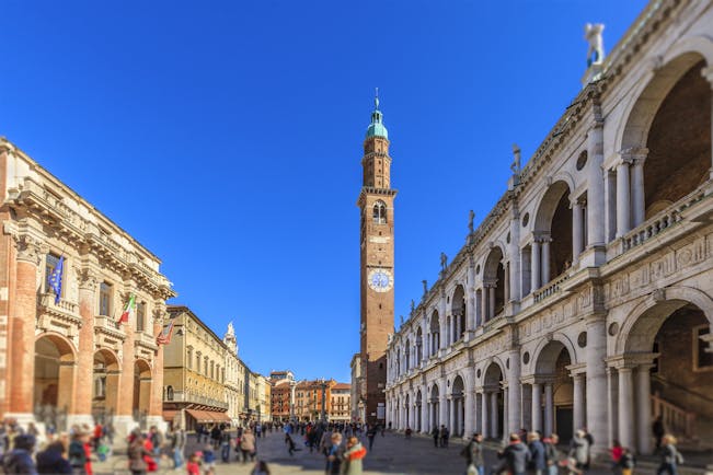 Tall campanile between arcaded buildings of Palladio in the Piazza dei Signori in Vicenza