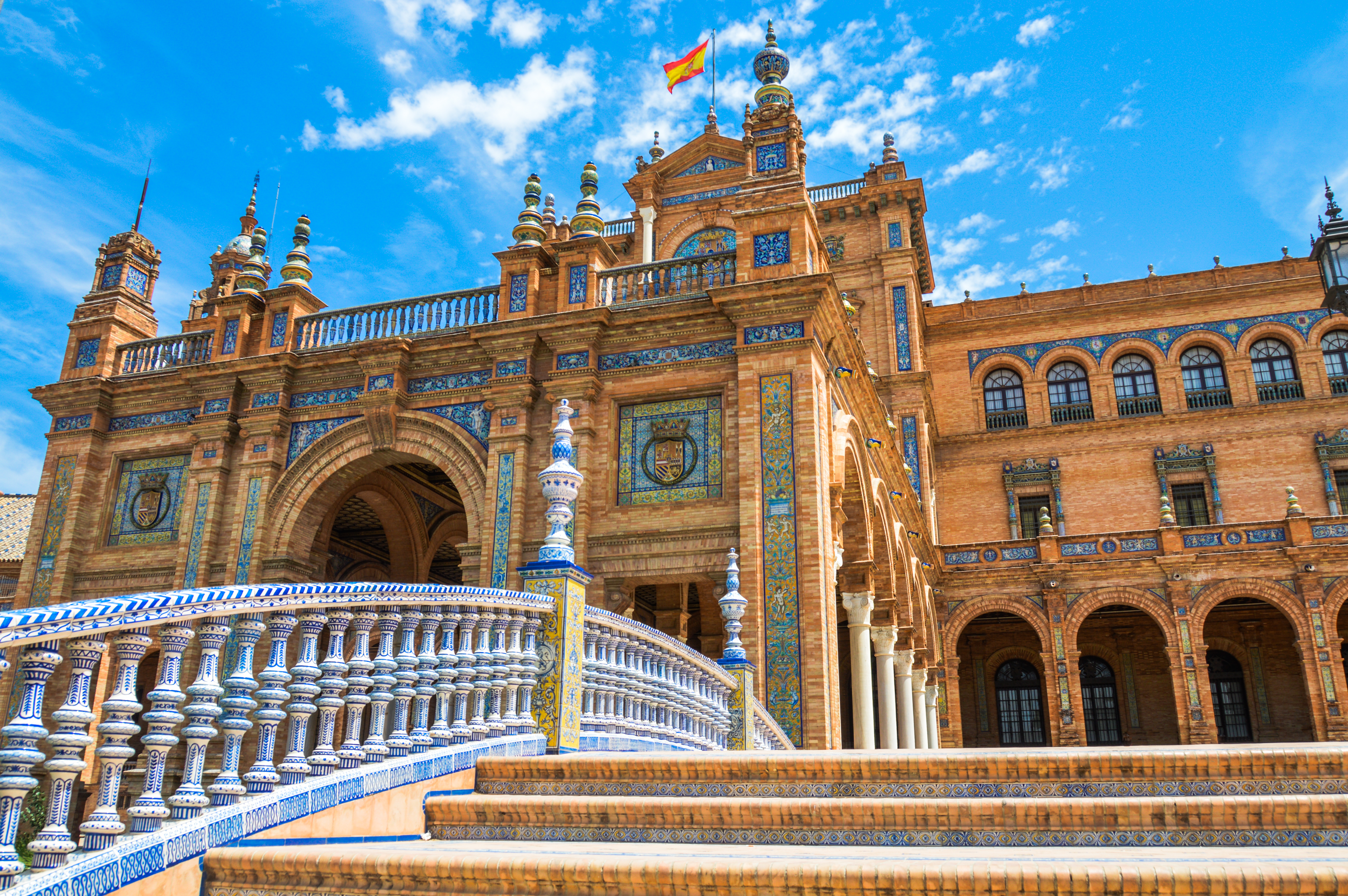 The orange brick and blue and white ceramics decorating the Plaza de Espana in Seville