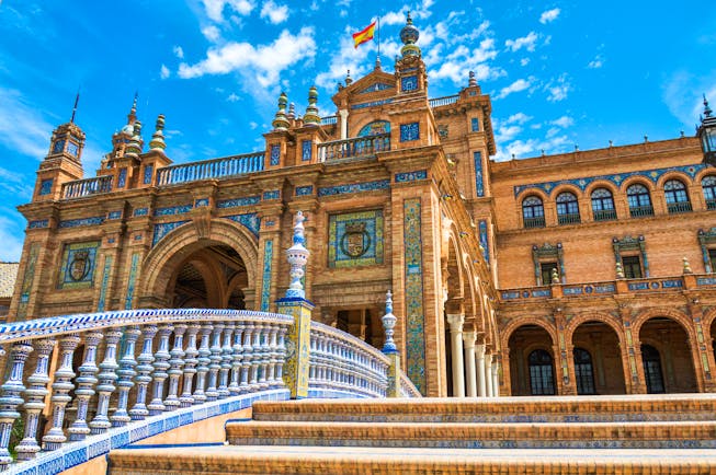 The orange brick and blue and white ceramics decorating the Plaza de Espana in Seville