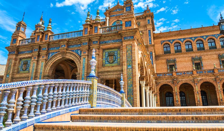 The orange brick and blue and white ceramics decorating the Plaza de Espana in Seville