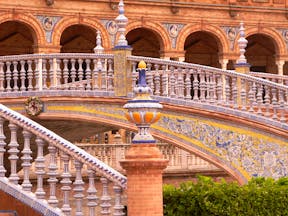 Ornate staircase with arches of building at the Plaza de Espana in Seville