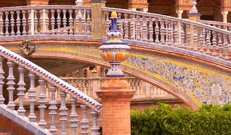 Ornate staircase with arches of building at the Plaza de Espana in Seville