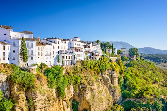 White washed houses in Ronda perched on the edge of the cliff