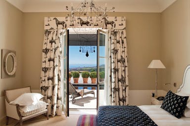 Finca Cortesin Andalucia pool suite bed chair modern décor terrace overlooking pool