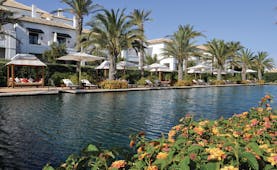 Finca Cortesin Andalucia pool sun loungers umbrellas palm trees