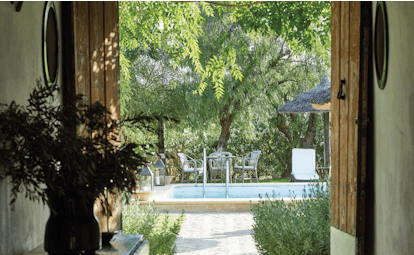 Hacienda de San Rafael Andalucia view of pool through door greenery 