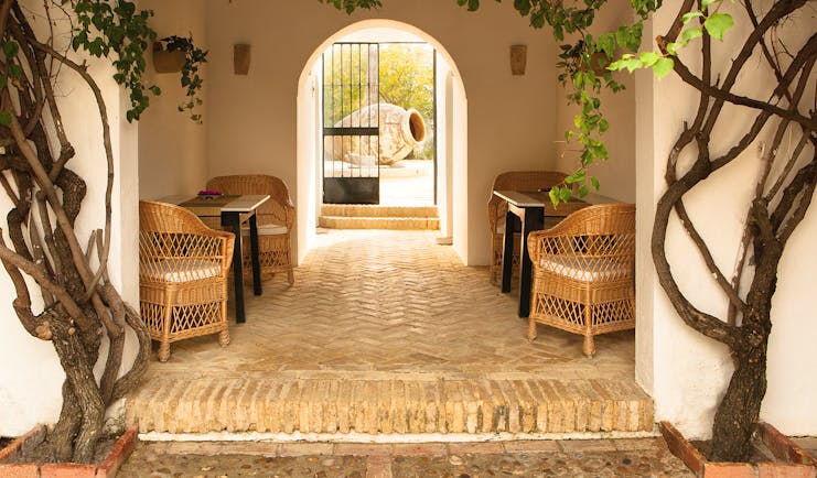 Courtyard with archway, chairs and vines