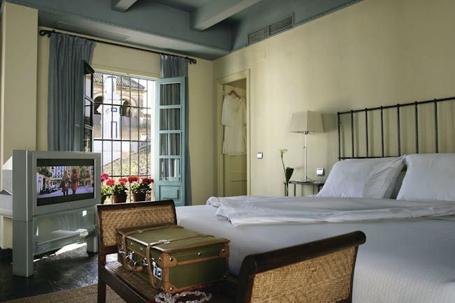 Las Casas del Rey Seville guest room bed television large window elegant décor