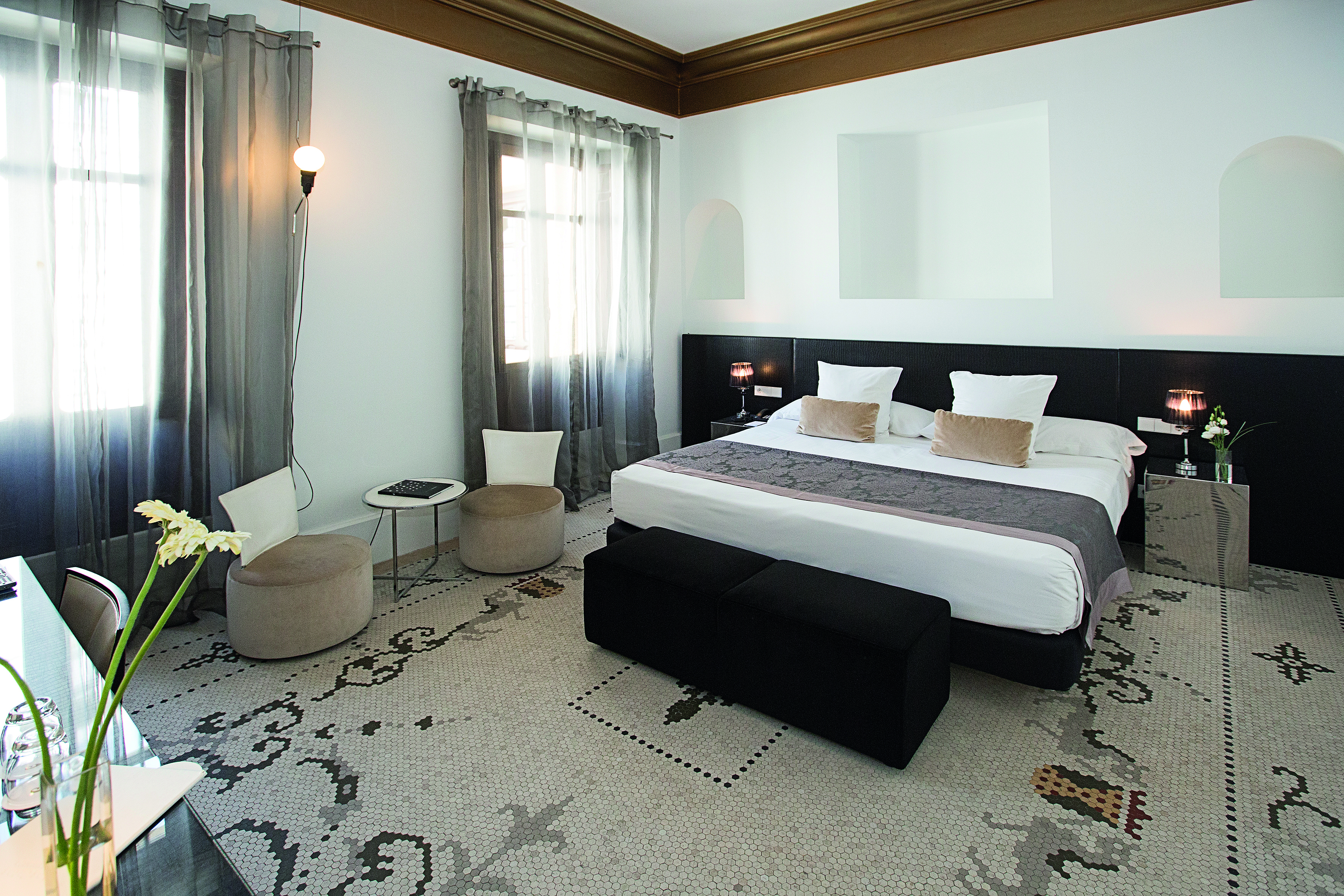 Palacio de los Patos Granada deluxe room bed chairs modern décor