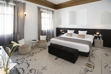 Palacio de los Patos Granada deluxe room bed chairs modern décor